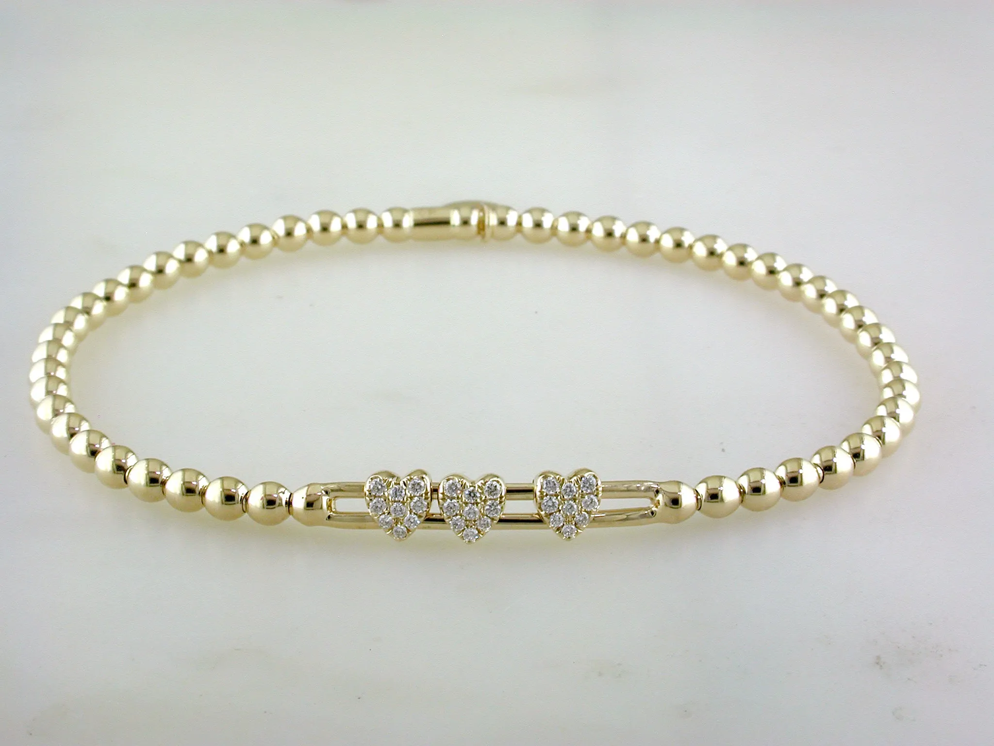 Hulchi Belluni Fidget Bracelet with Three Pave Diamond Moveable Heart Stations Yellow Gold Stretch Stackable